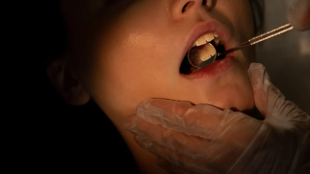 Patient receiving gentle dental treatment with mirror tool at Core Dental Hub in Kokapet, showcasing a calm, stress-free approach for dental anxiety patients.