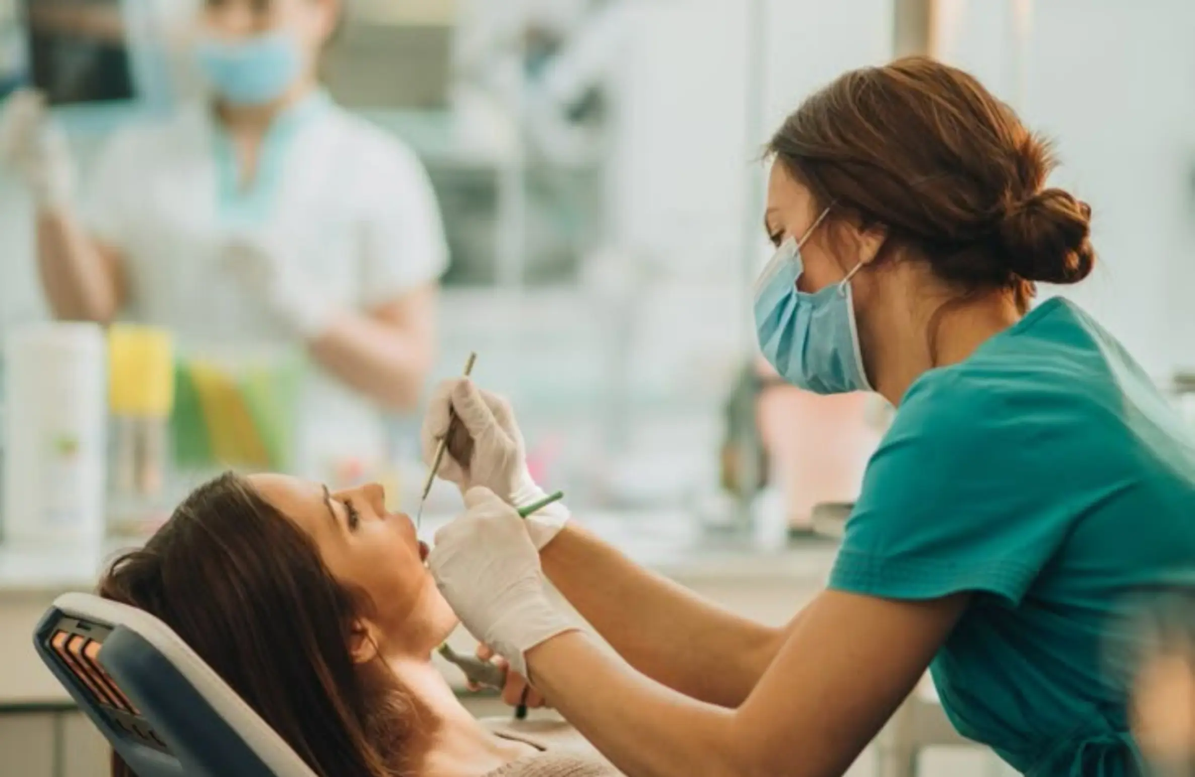 Dentist examining a patient’s teeth in a modern dental clinic, highlighting the cost of common dental treatments in Hyderabad (2026 guide) at Core Dental Hub